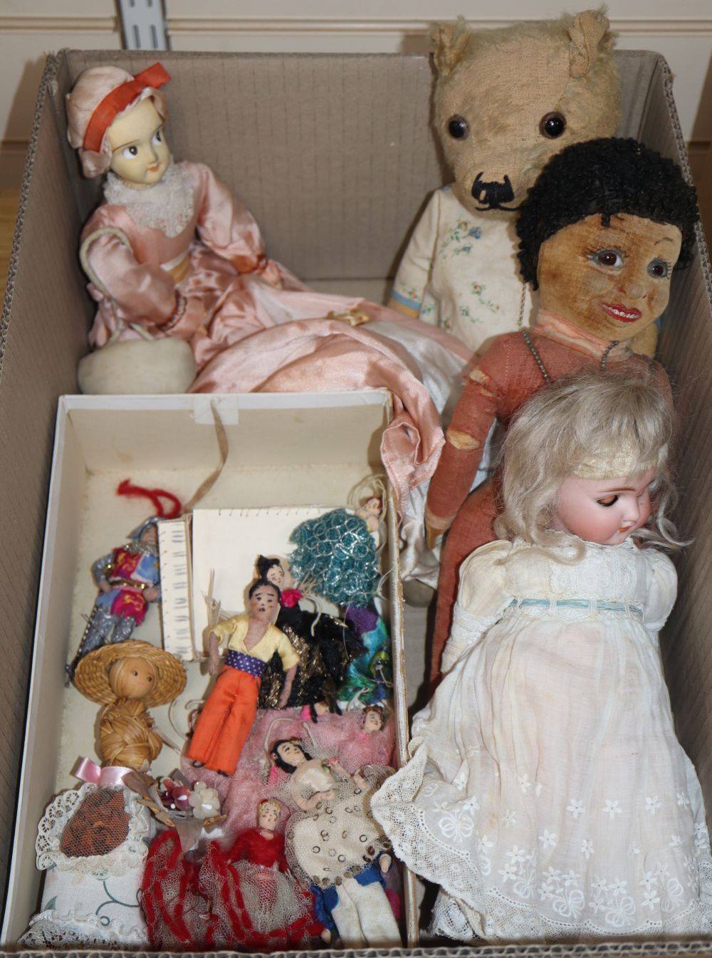 A Simon Halbig open mouthed doll, a Norah Wellings style doll, a 1920s wooden doll, a teddy and a collection of handmade miniature dol